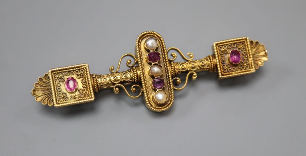 A Victorian Etruscan style gold filigree work brooch, set with pearls and amethysts, 57mm, gross 8 grams.